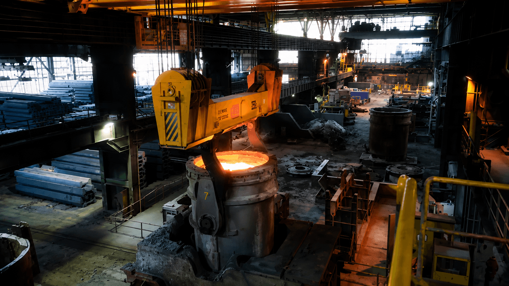 An overhead crane on a glowing ladle of molten steel — the unforgiving operations the world depends on.